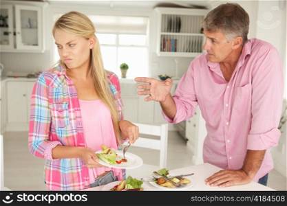 Father making teenage daughter do chores at home