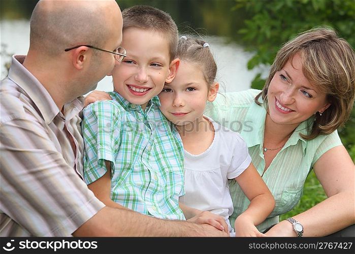 father, mother, little boy and little girl near pond. focus on little girl&acute;s face