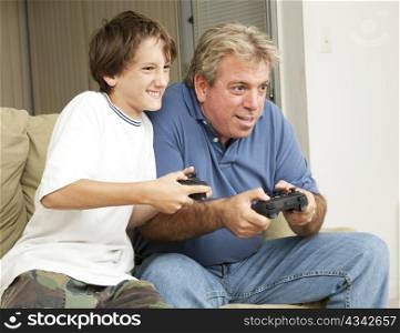 Father or uncle playing video games with a little boy - his son or nephew.