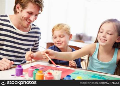 Father Painting Picture With Children At Home