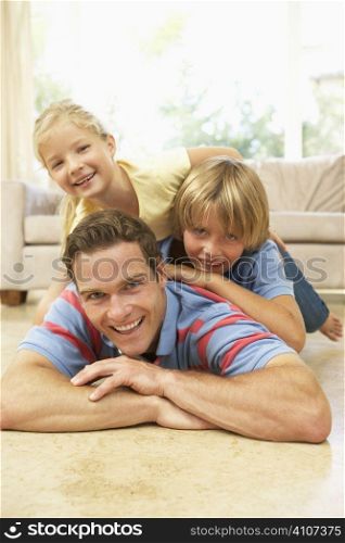 Father Playing With Children At Home