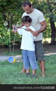 Father playing with son with a diabolo
