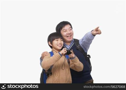 Father pointing with son holding digital camera