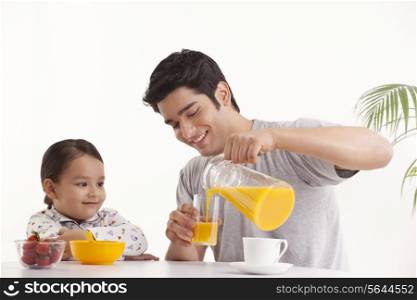 Father pouring juice in the glass