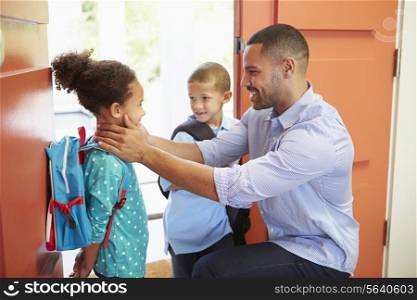 Father Saying Goodbye To Children As They Leave For School