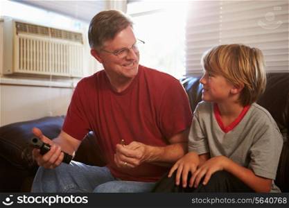 Father Showing Son How To Use Gun At Home