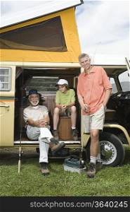 Father son and grandson in campervan prepare to go fishing