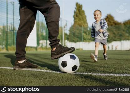 father son playing football