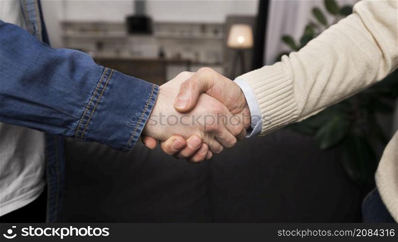 father son shaking hands