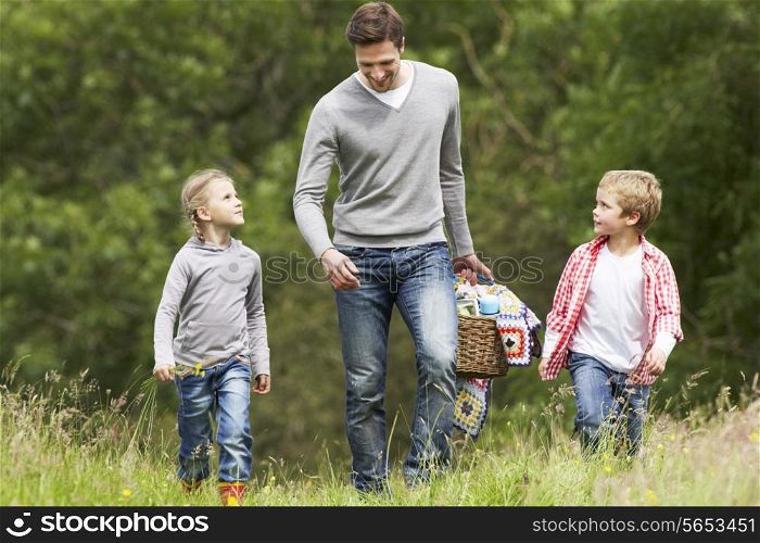 Father Taking Children On Picnic In Countryside