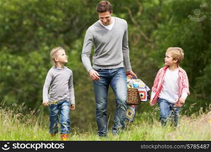 Father Taking Children On Picnic In Countryside