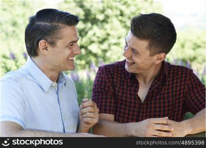 Father Talking To Adult Son Outdoors