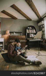 Father teaching daughter to play guitar in the room at home