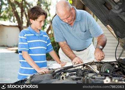 Father teaching his son basic auto maintenance.