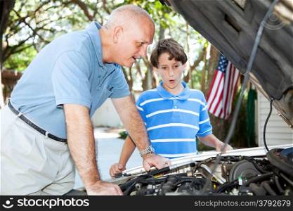 Father teaching his son how to do auto repair.