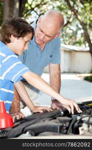 Father teaching his son how to do auto repairs, oil change, etc.