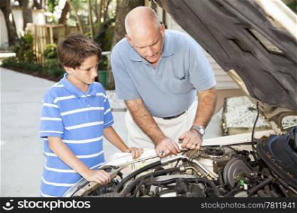 Father teaching his son how to repair the car.