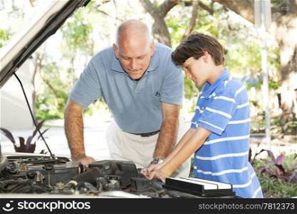 Father teaching his son how to service and repair the car.