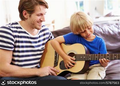 Father Teaching Son To Play Guitar