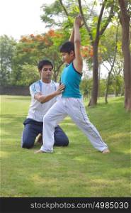 Father teaching son yoga