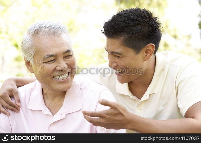 Father With Adult Son In Park