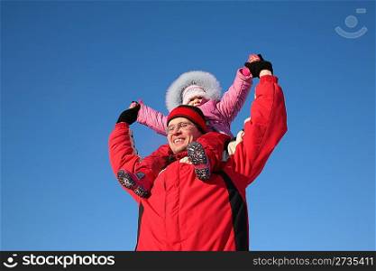 father with child on shoulders in winter 2