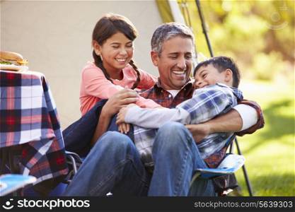 Father With Children Enjoying Camping Holiday In Countryside