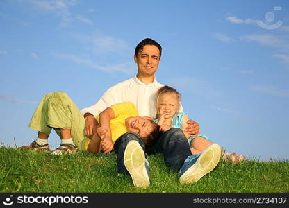 father with children on grass