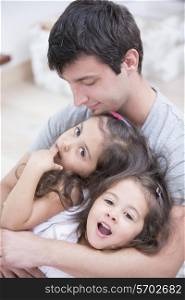 Father with daughters relaxing at home