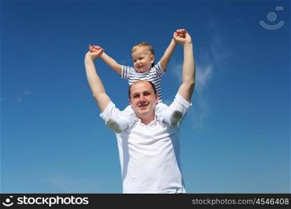 father with his child outdoor against blue sky