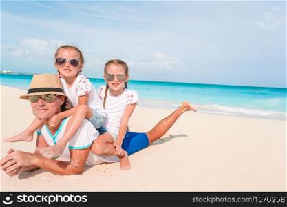 Father with kids on the beach. Family vacation. Happy beautiful family on a tropical beach vacation