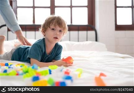 Father with little boy have fun playing with your new toys in the bedroom together. Toys that enhance children’s thinking skills.
