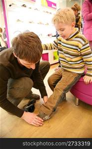 father with son in shop