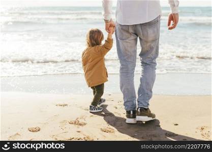 father with son looking sea