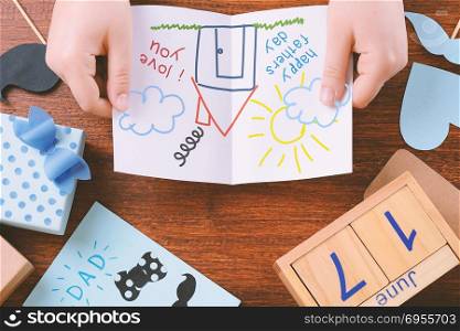 Fathers day composition with space for with child&rsquo;s drawing on wooden background