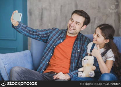 fathers day concept with father daughter taking selfie