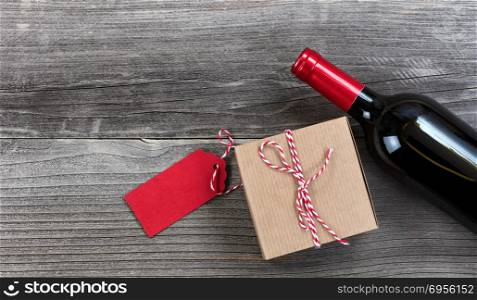 Fathers day gift box with red wine bottle on vintage wooden plank background