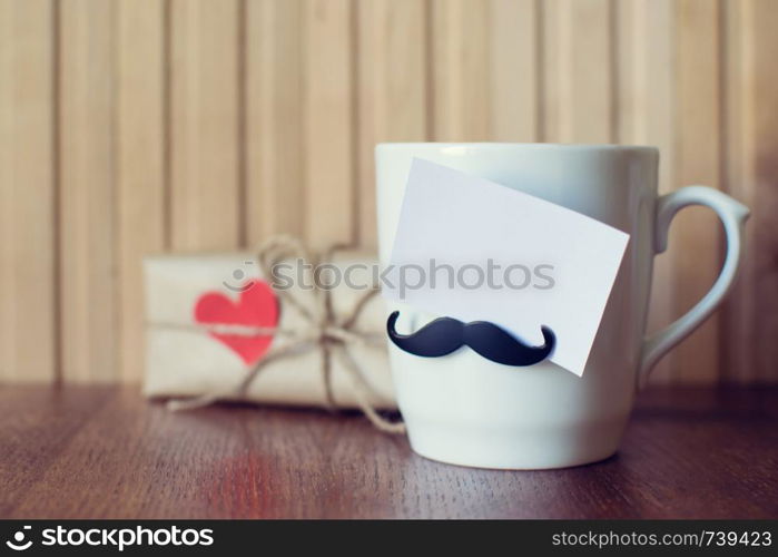 Fathers day. Greeting card on Cup with funny mustache over wooden board. Happy birthday. Valentines day. Mockup. Greeting card on Cup with funny mustache over wooden board. Fathers day. Happy birthday. Valentines day. Mockup