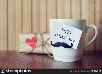 Fathers day. Greeting Message card on the Cup with funny mustache over wooden board.. Fathers day. Greeting Message, Cup with funny mustache over wooden board.