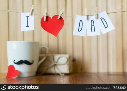 Fathers day message with red paper hearts hanging with clothespins over wooden board.. Fathers day greeting. Message with paper heart hanging with clothespins over wooden board. Happy Birthday