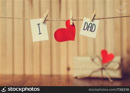 Fathers day message with red paper hearts hanging with clothespins over wooden board.. Message with paper heart hanging with clothespins over wooden board. Fathers day greeting. Happy Birthday