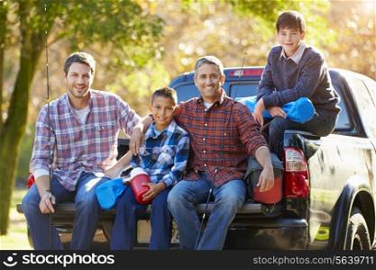 Fathers With Sons Sitting In Truck On Camping Holiday