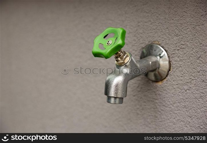 faucet with green valve, closeup photo