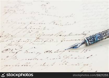 feather pen . old feather pen on handwritten letter background