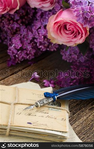 feather pen . old pastage with flowers and blue feather pen