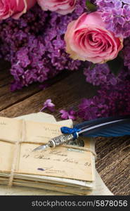 feather pen . old pastage with flowers and blue feather pen