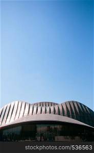 FEB 2, 2015 Abu Dhabi, UAE - Grand modern building with extraordinary design steel roof of Manarat Al Saadiyat - Contemporary Culture and Art Museum with under sunlight and blue sky