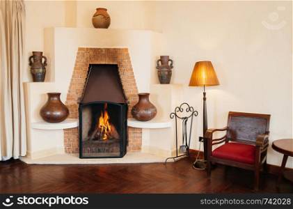 FEB 25, 2014 Dalat, Vietnam - Vintage retro old brick fireplace wooden chairs and lamp in hard wood floor living room in French colonial house