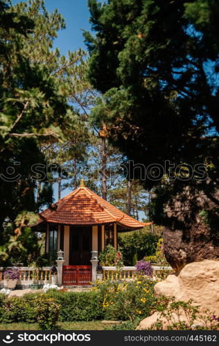 FEB 26, 2014 Dalat, Vietnam - Chinese Pavilion at Truc Lam Da Lat Zen Monastery - Vietnamese buddhist temple with Asian style garden and big tree