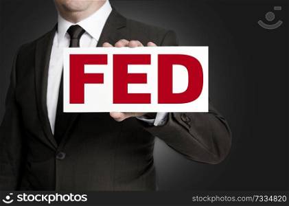 fed sign is held by businessman background.. fed sign is held by businessman background